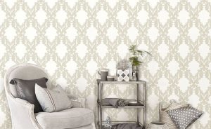 Stylish living room in shades of grey with antique armchair, fur rug and metal chandelier with bird ornaments